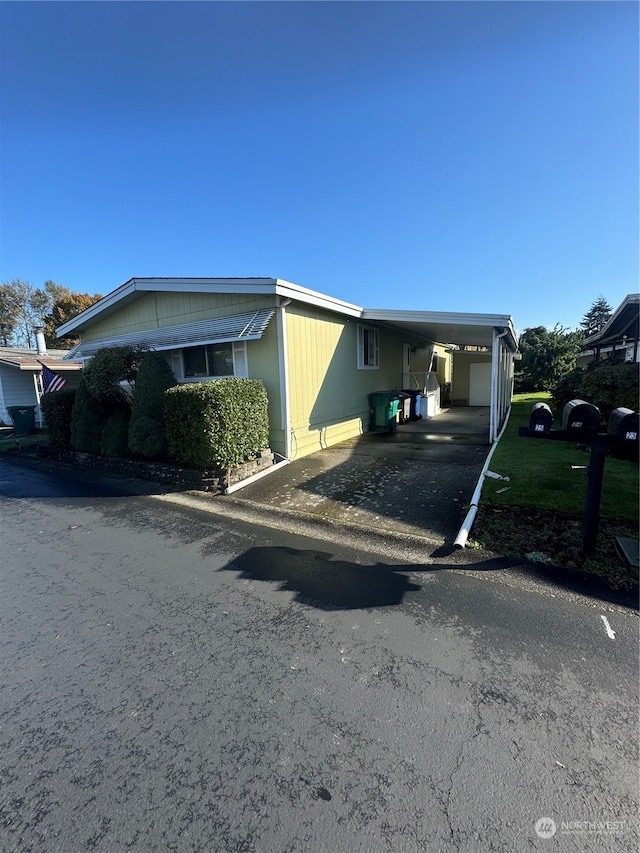 view of front of house featuring a garage and a carport