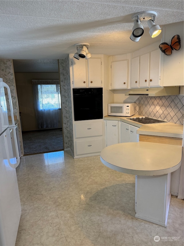 kitchen featuring white cabinetry, a textured ceiling, white appliances, and tasteful backsplash