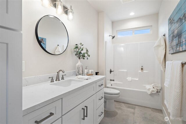 full bathroom with tile patterned flooring, vanity, bathing tub / shower combination, and toilet