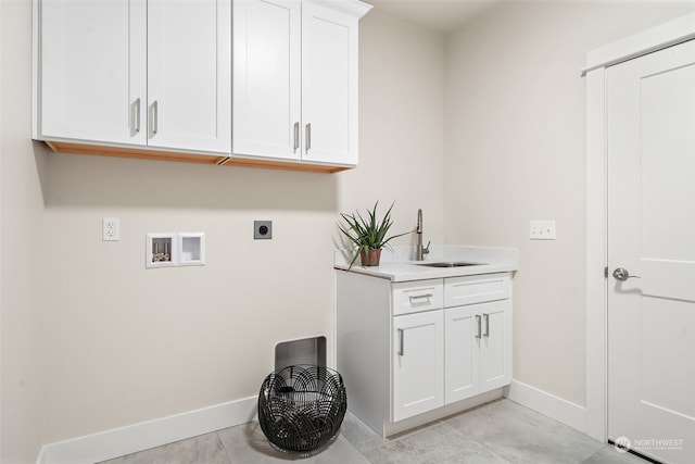 clothes washing area featuring light tile patterned flooring, hookup for a washing machine, cabinets, sink, and electric dryer hookup