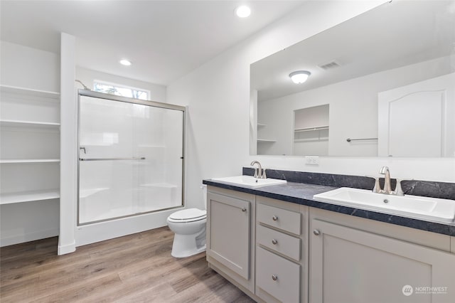 bathroom with vanity, wood-type flooring, toilet, and walk in shower