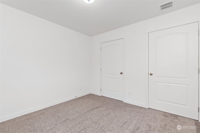 unfurnished bedroom featuring light carpet