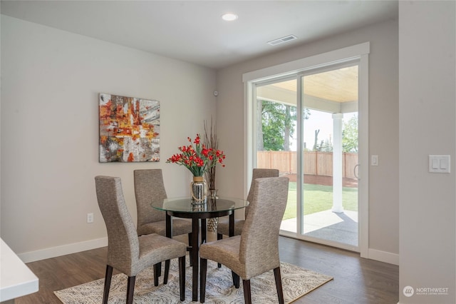 dining area featuring dark wood-type flooring