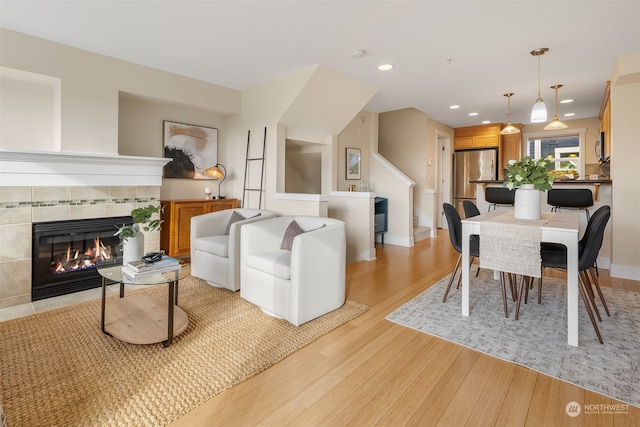 living room featuring a fireplace and light wood-type flooring