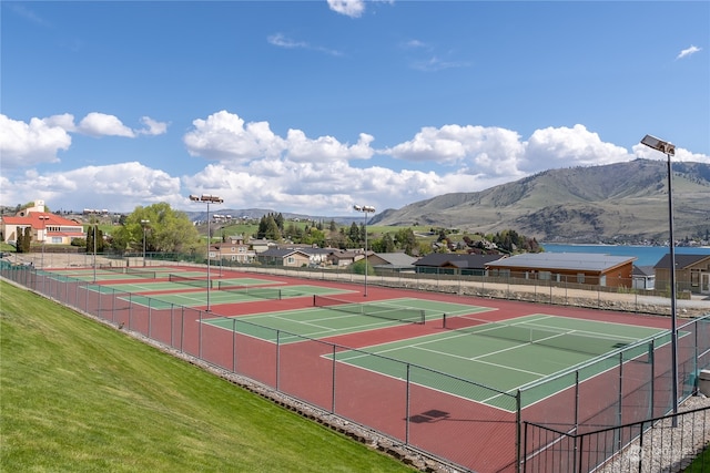 view of sport court with a yard and a mountain view