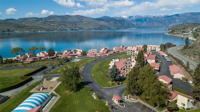 drone / aerial view featuring a water and mountain view