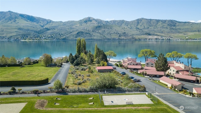 birds eye view of property with a water and mountain view