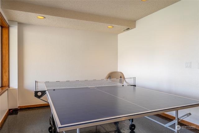 rec room with a textured ceiling