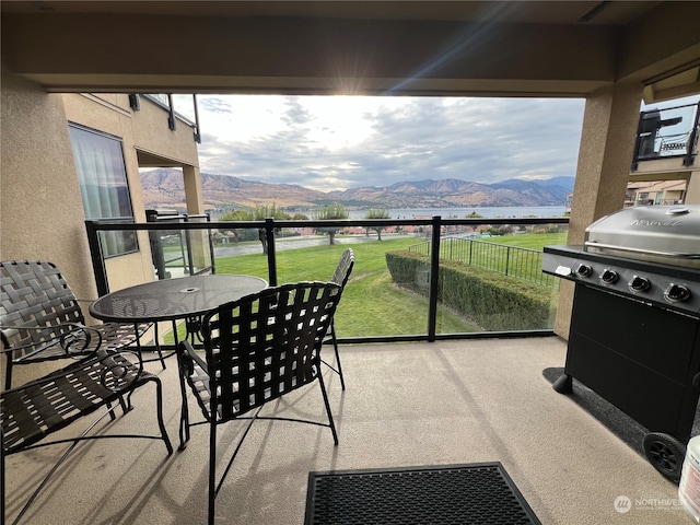 balcony with a mountain view and a grill