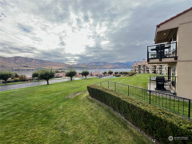 view of yard featuring a balcony and a mountain view