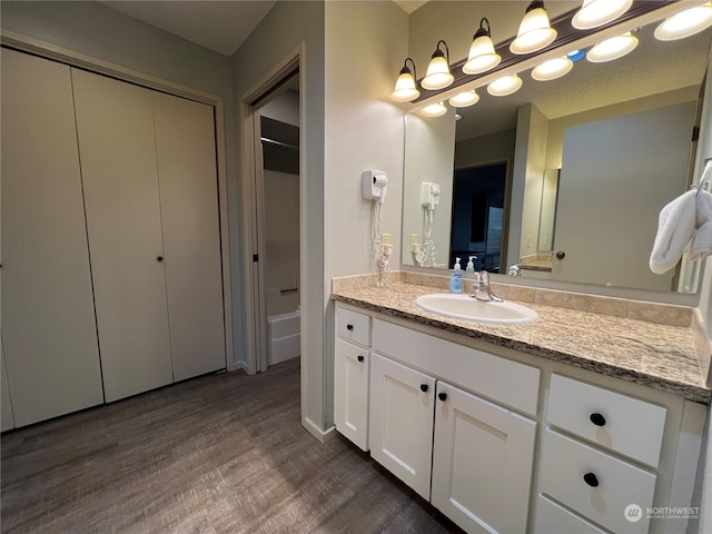 bathroom featuring vanity and wood-type flooring