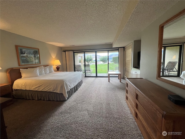 bedroom with access to outside, a textured ceiling, and carpet