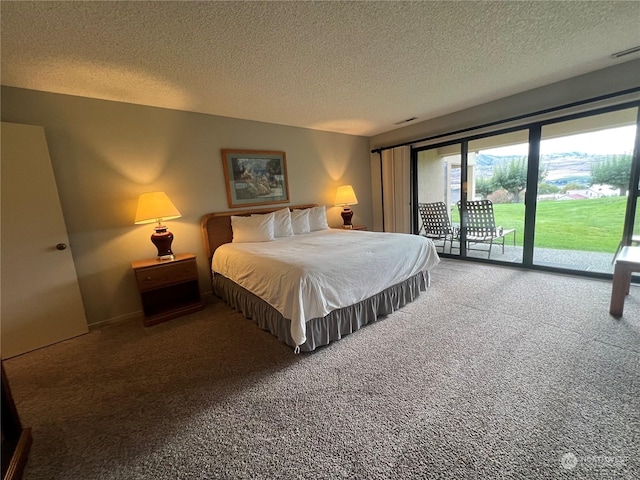 bedroom featuring access to outside, carpet floors, and a textured ceiling