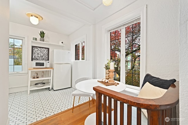 interior space with hardwood / wood-style flooring and beamed ceiling