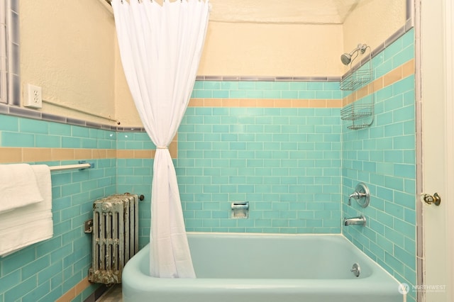 bathroom featuring tile walls, radiator heating unit, and shower / bath combo