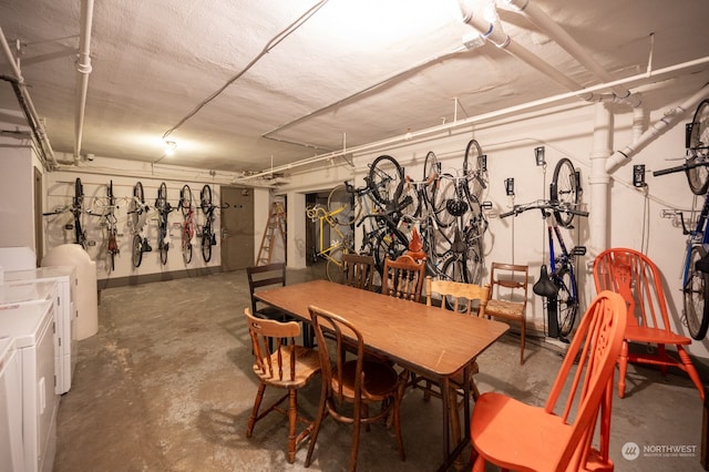 dining space with independent washer and dryer and concrete floors