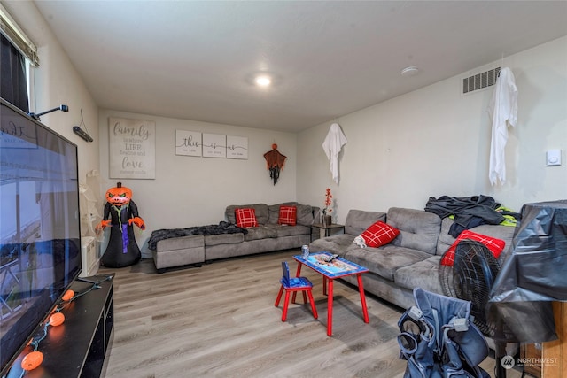 living room with light hardwood / wood-style flooring