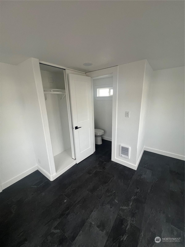 unfurnished bedroom with a closet