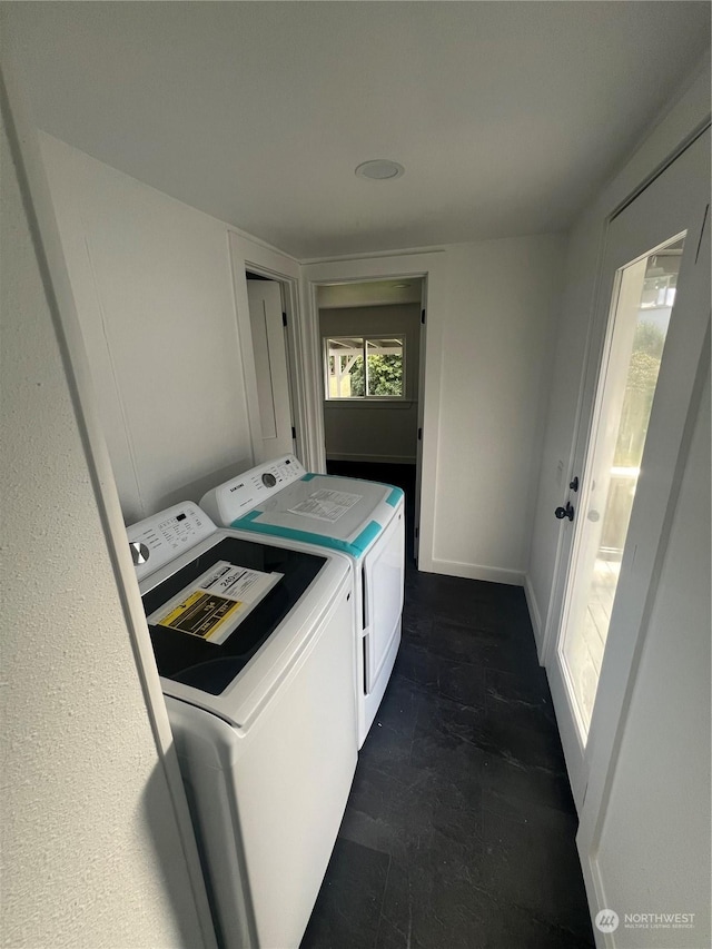 clothes washing area featuring washer and clothes dryer