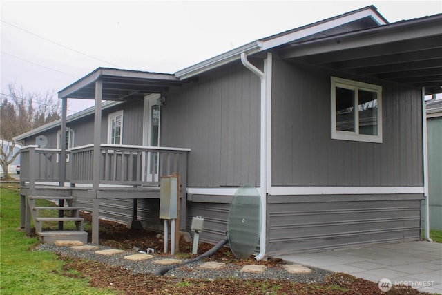 view of side of home with concrete driveway