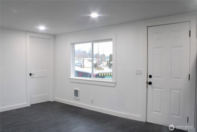 empty room featuring baseboards, dark wood-type flooring, and recessed lighting