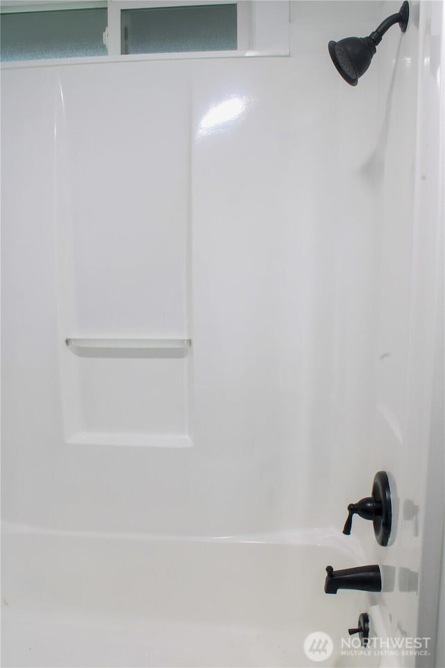 interior details featuring shower / tub combination