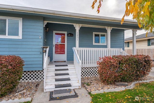 property entrance with covered porch