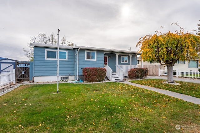 view of front facade with a storage unit and a front yard