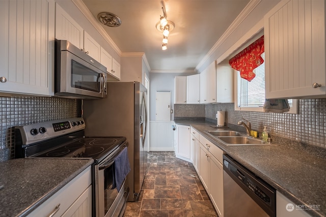 kitchen with stainless steel appliances, white cabinetry, sink, tasteful backsplash, and crown molding