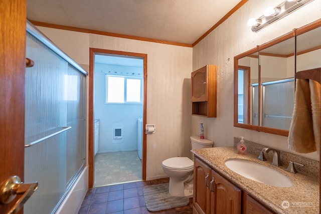 full bathroom featuring enclosed tub / shower combo, tile patterned flooring, vanity, crown molding, and washer / dryer