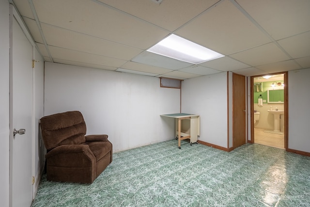 interior space featuring carpet and a paneled ceiling