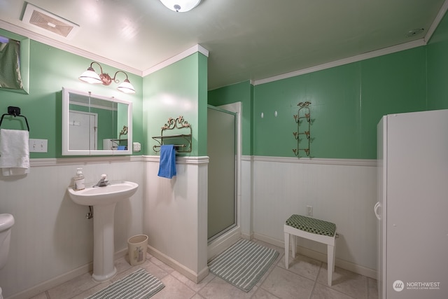 bathroom with walk in shower, tile patterned flooring, ornamental molding, and sink