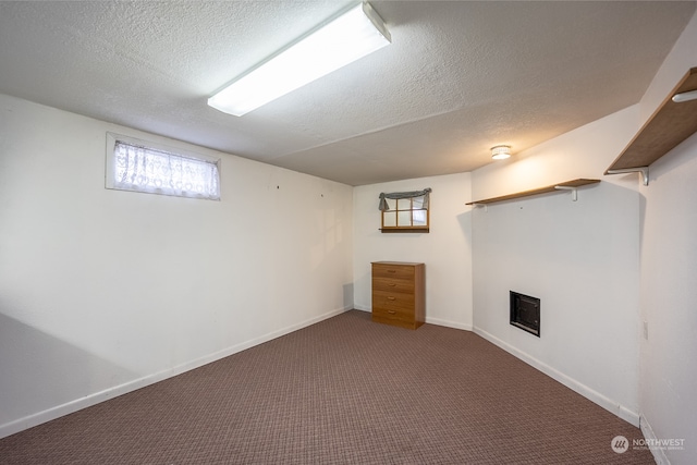 basement with carpet flooring and a textured ceiling