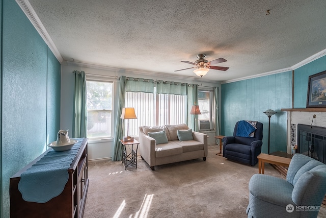 living room with a fireplace, ceiling fan, carpet flooring, and crown molding