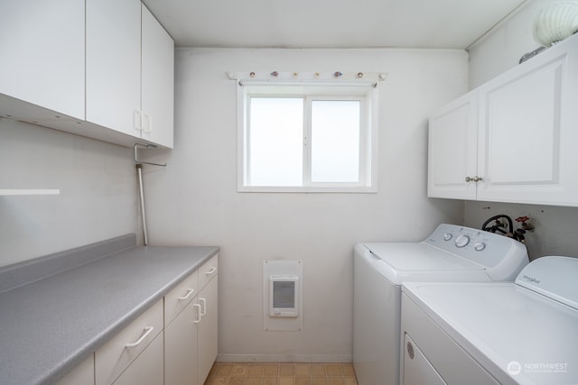 clothes washing area featuring cabinets and washer and dryer