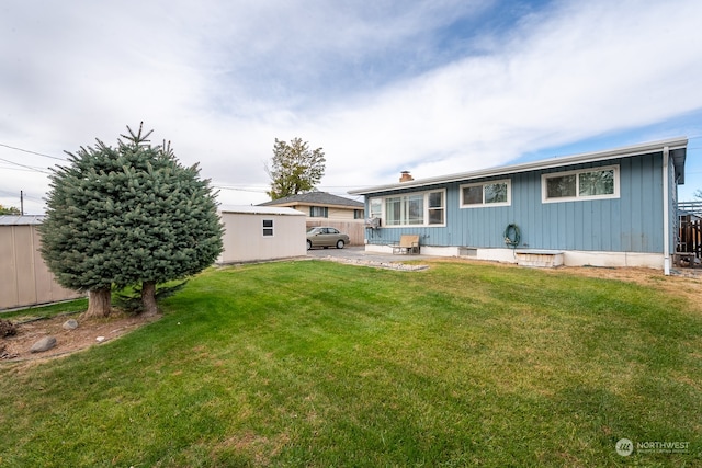 back of property featuring a patio and a yard