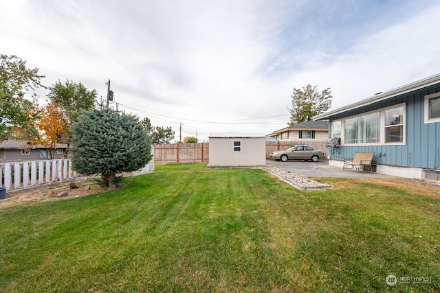 view of yard featuring a patio area and a storage unit