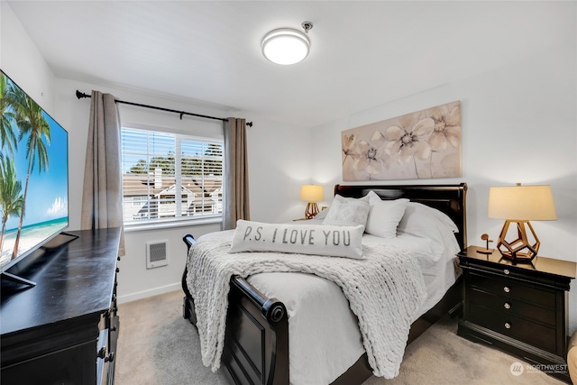 bedroom featuring light colored carpet