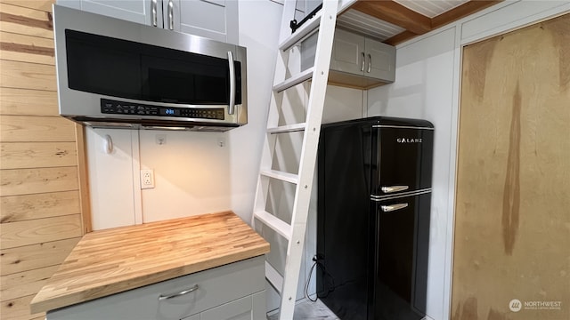 kitchen featuring wooden walls and butcher block counters