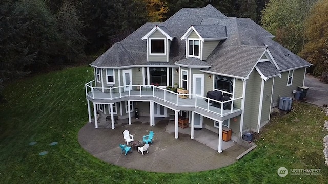 back of property featuring a deck, a lawn, central AC unit, and a patio area