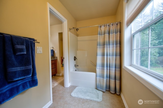 bathroom with tile patterned flooring, plenty of natural light, vanity, and shower / tub combo