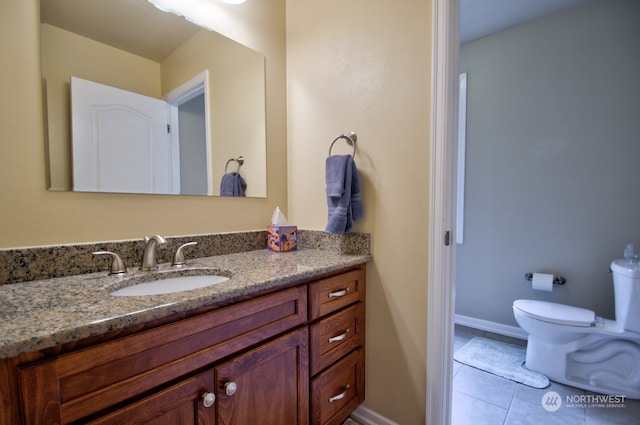 bathroom featuring tile patterned flooring, vanity, and toilet