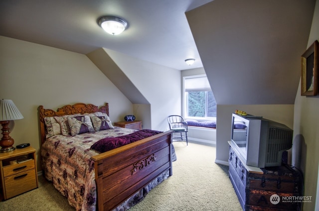 carpeted bedroom with vaulted ceiling