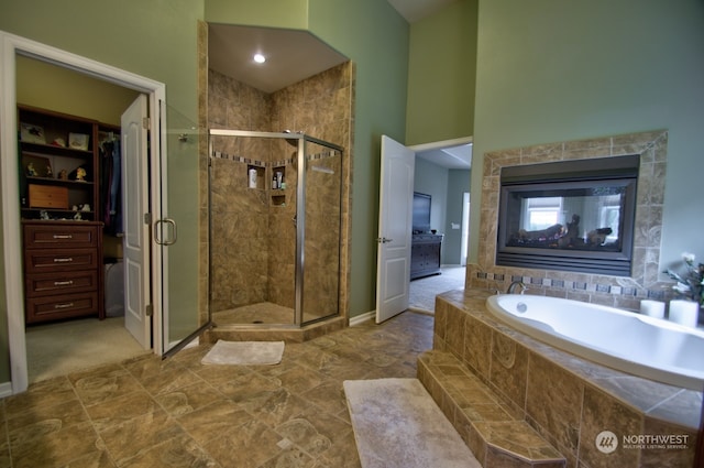 bathroom featuring a towering ceiling and plus walk in shower