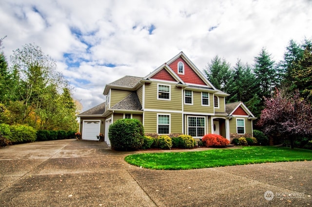 view of front of home with a garage and a front yard