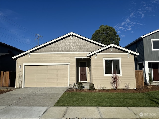 view of front of property featuring a garage and a front lawn