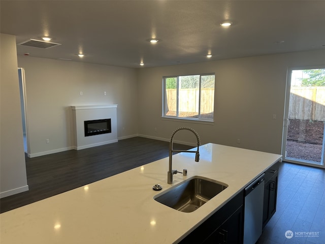 kitchen with dishwasher, a healthy amount of sunlight, sink, and dark wood-type flooring