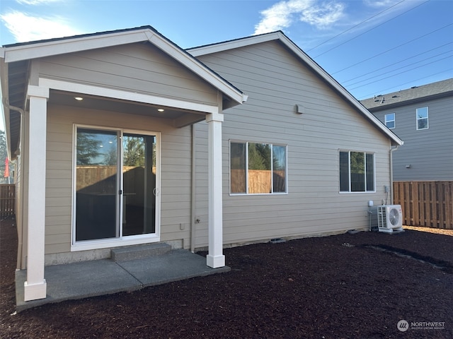 rear view of house featuring ac unit