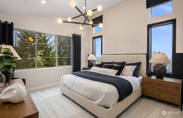 carpeted bedroom with a notable chandelier and lofted ceiling