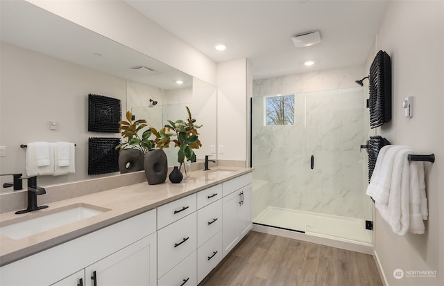 bathroom with vanity, wood-type flooring, and walk in shower